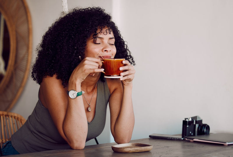 Woman drinking from a mug in a cozy indoor setting