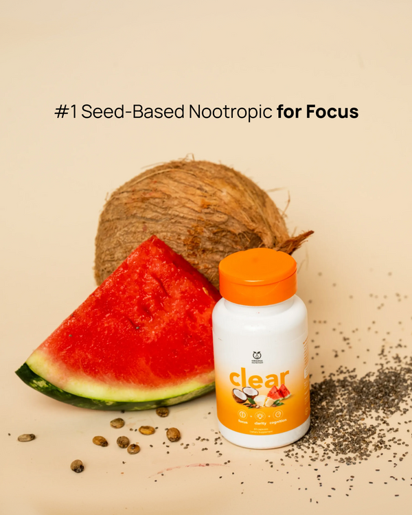A bottle of Clear Seed-Based Nootropic supplement with an orange cap, styled with a watermelon slice, a whole coconut, scattered seeds, and text on a beige background.