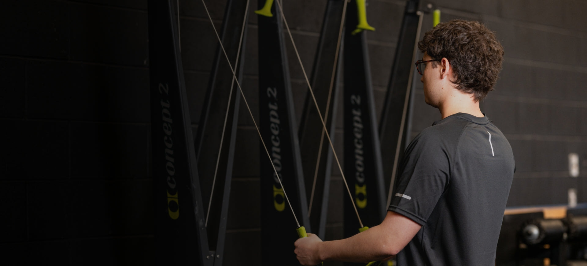 Person holding a lacrosse stick in front of lacrosse bags with 'chinook' branding.