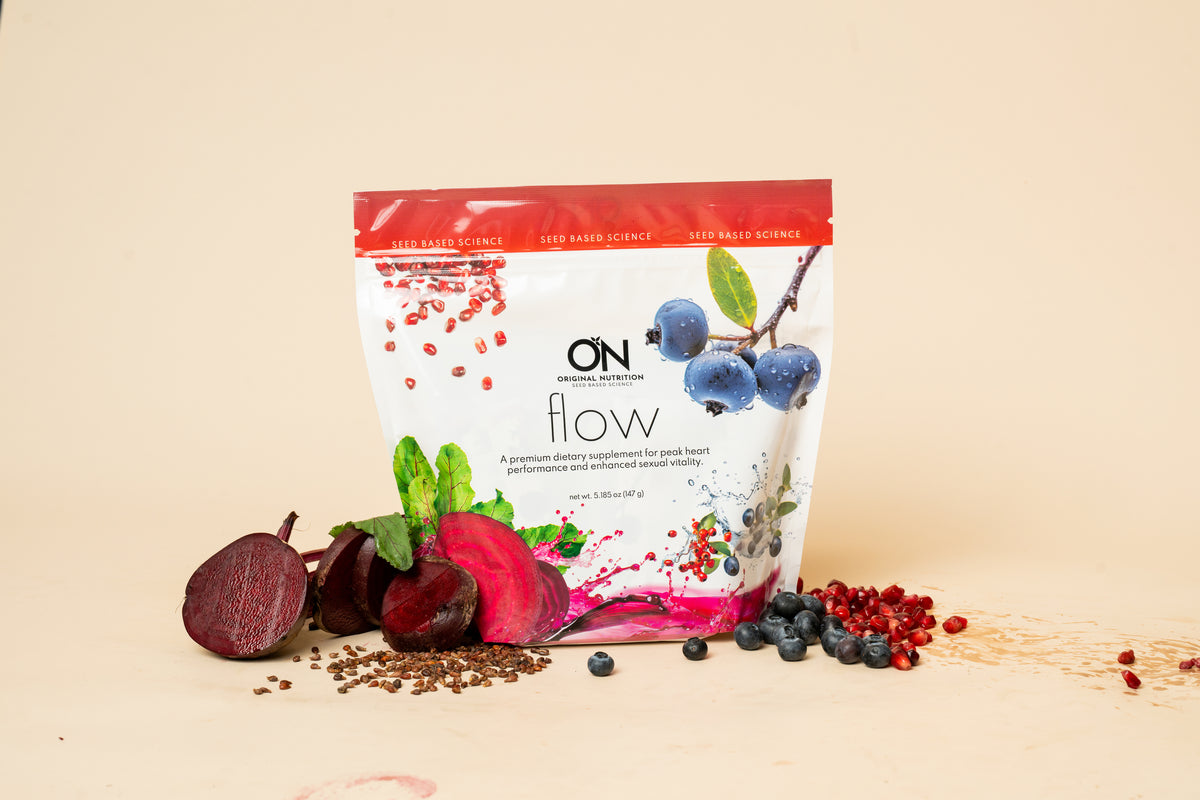 A stand-up pouch of ON Nutrition 'flow' protein powder supplement, styled with fresh ingredients like sliced beets, blueberries, and red berries on a warm beige background.