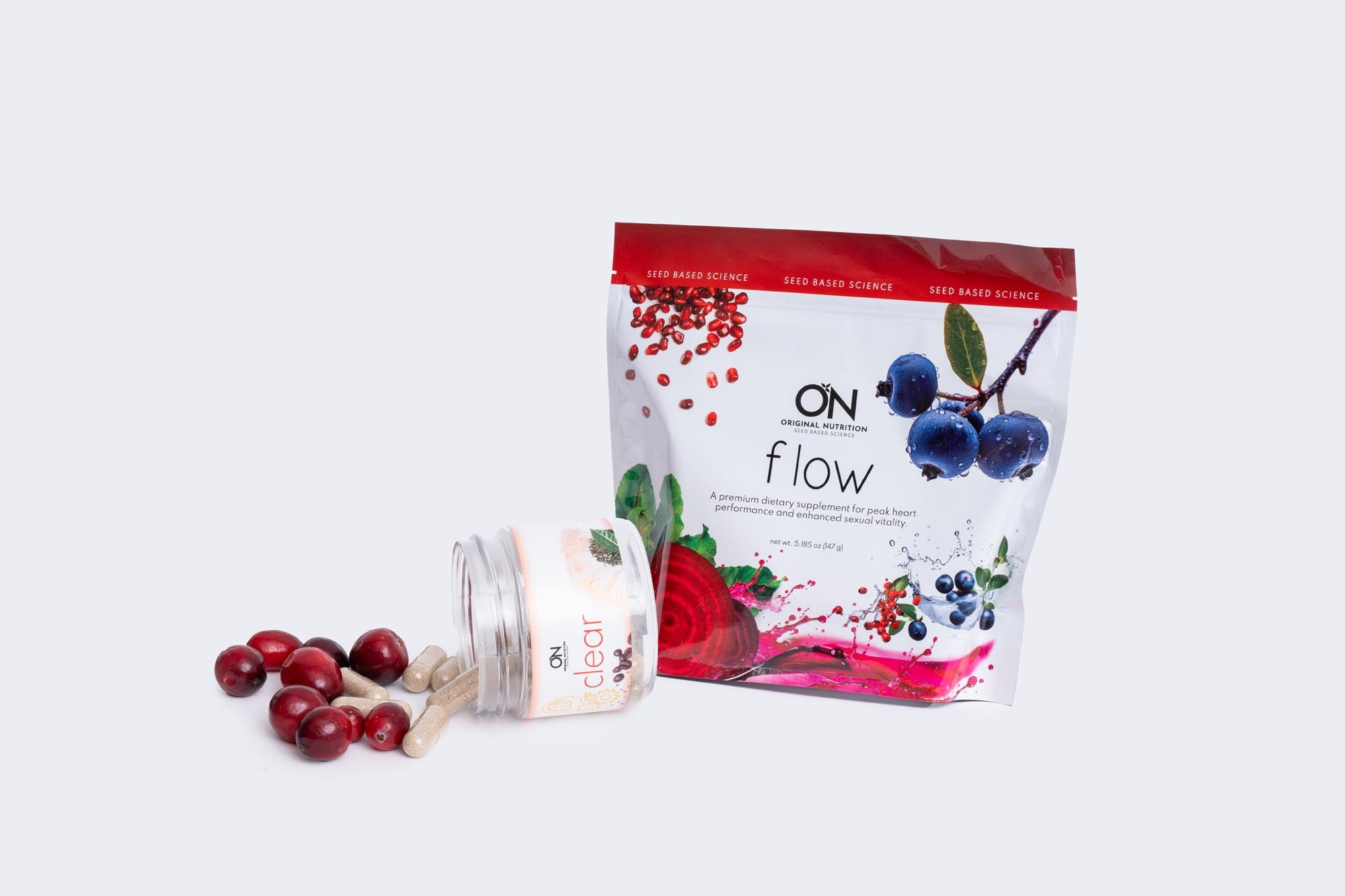 Onnit Flow supplement packaging with berries on a white background